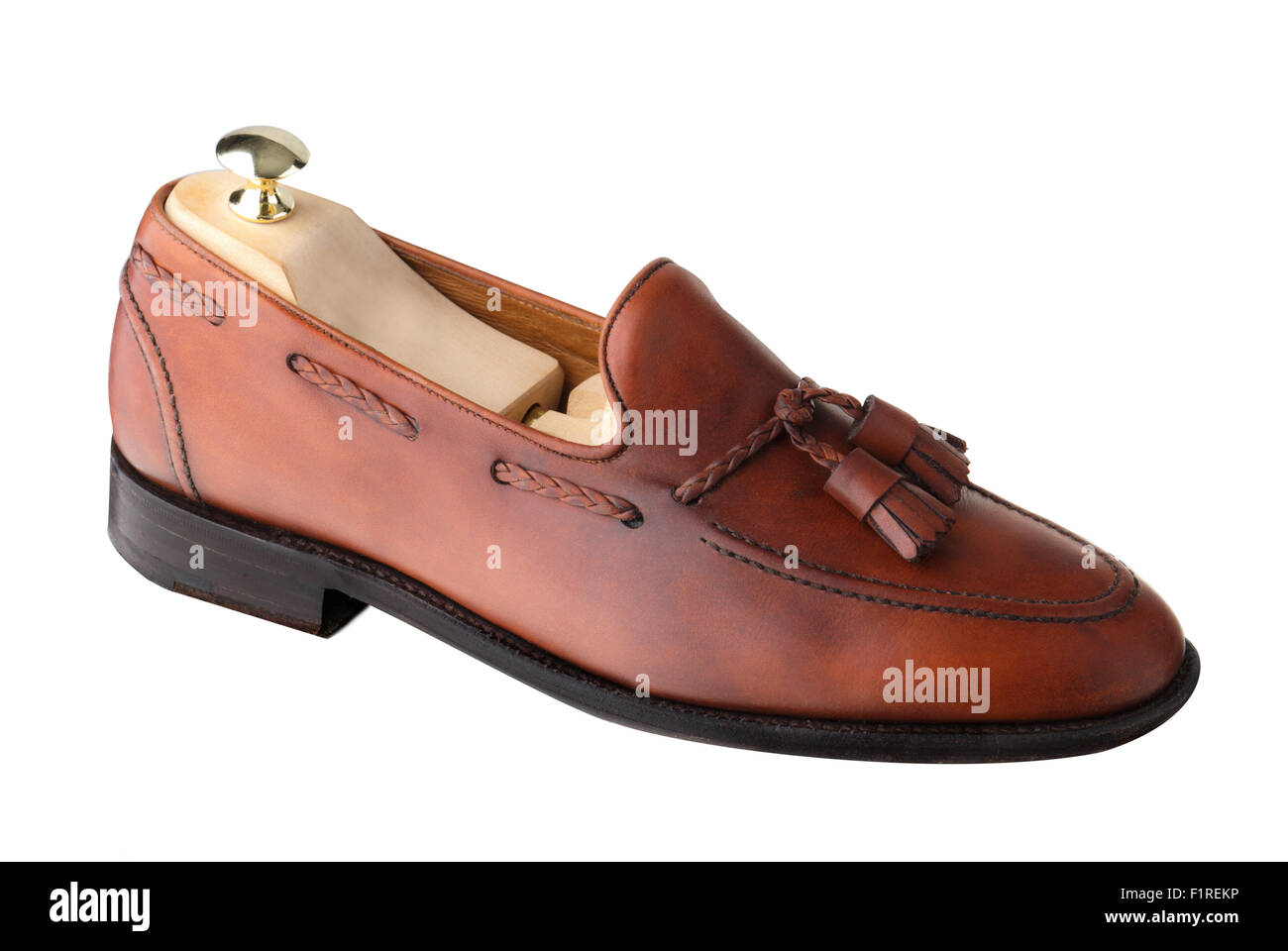 Almost unworn, single tasseled, handcrafted men's loafer with shoe tree inserted.  The upper is dark leaf calf. Stock Photo