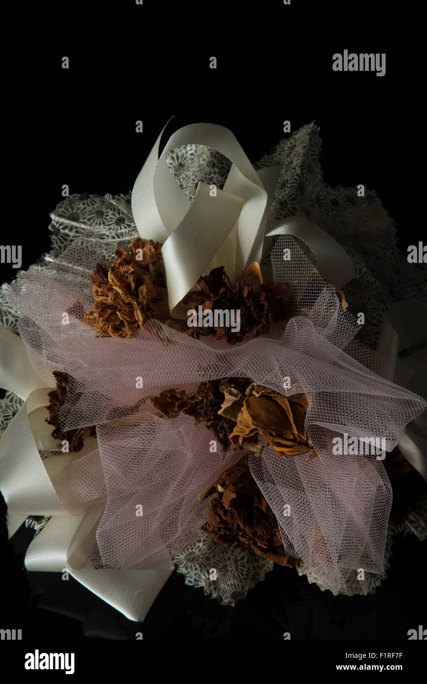 Dried flowers in white lace and ribbon Stock Photo