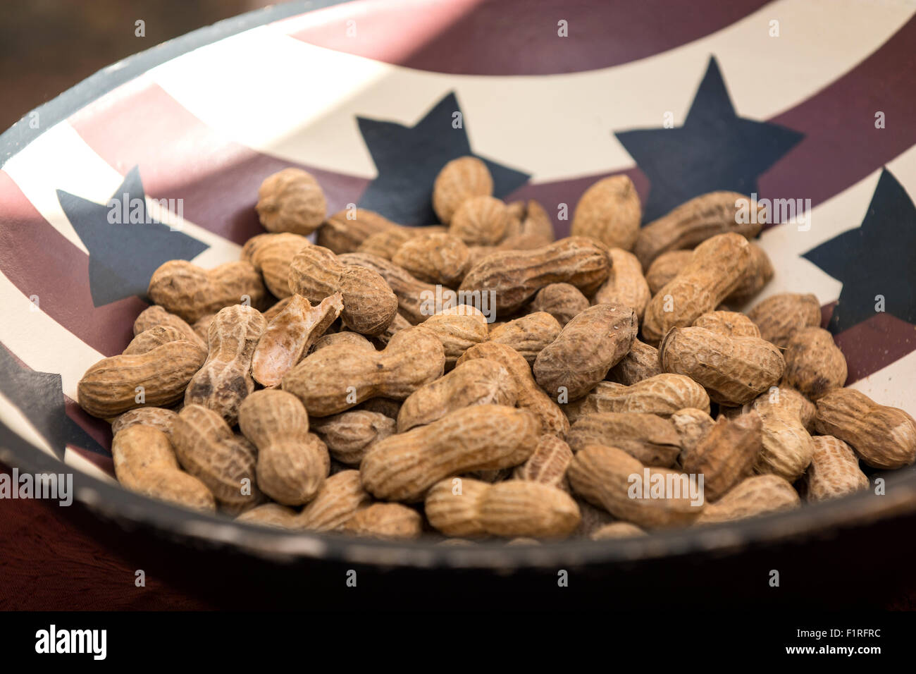 A bowl of unshelled peanuts. Stock Photo