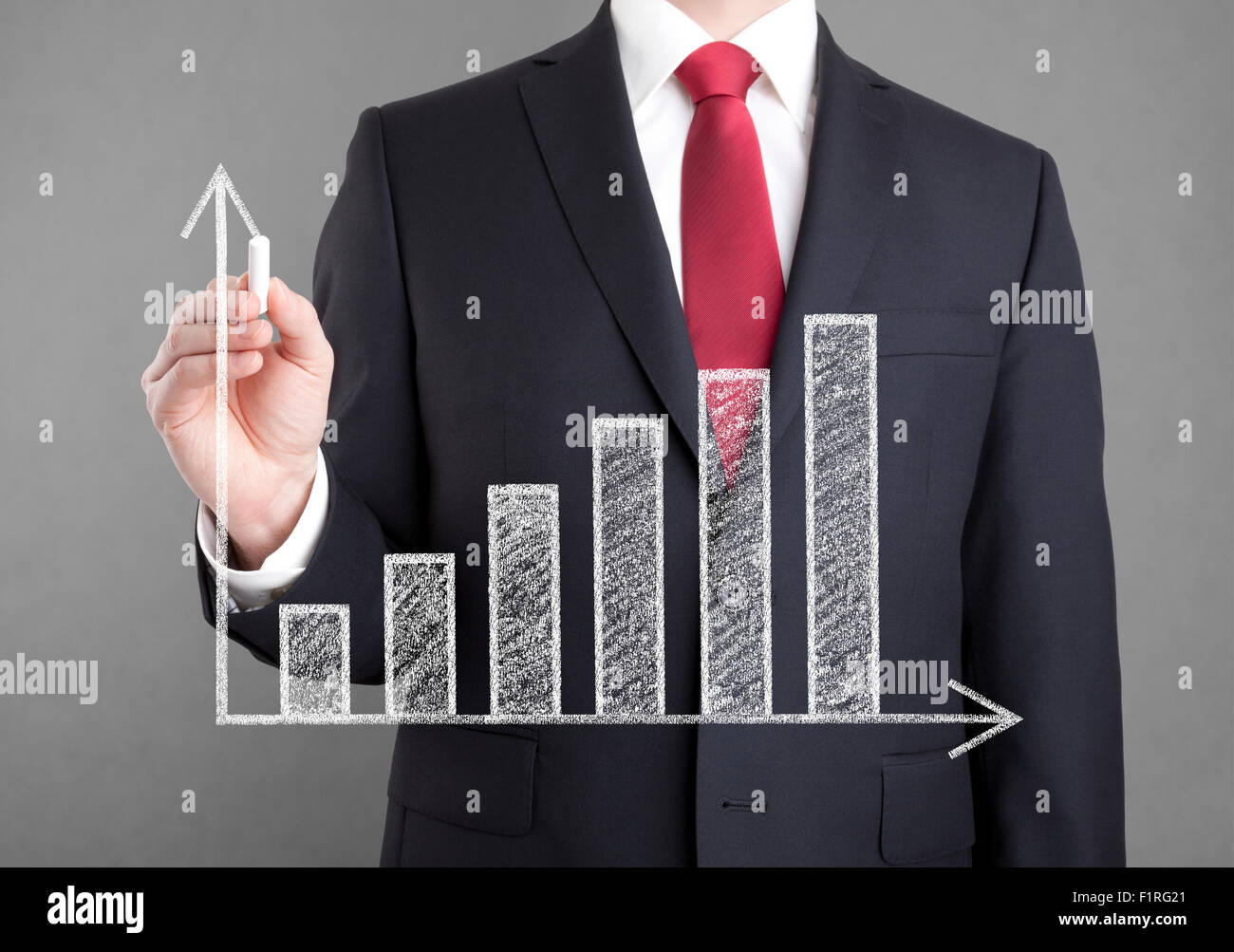 Businessman drawing a growing chart with chalk Stock Photo - Alamy