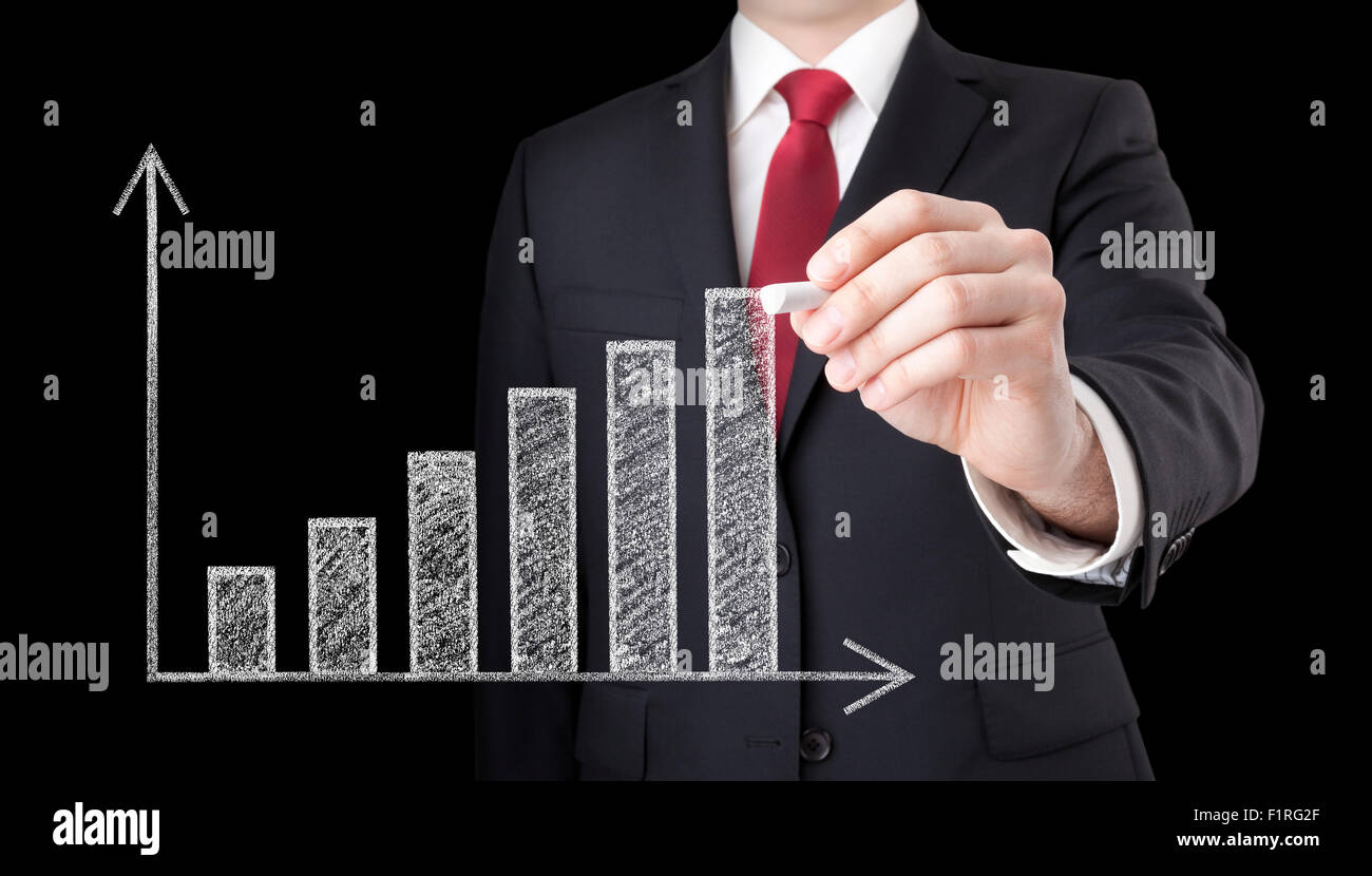 Businessman drawing a growing chart with chalk Stock Photo