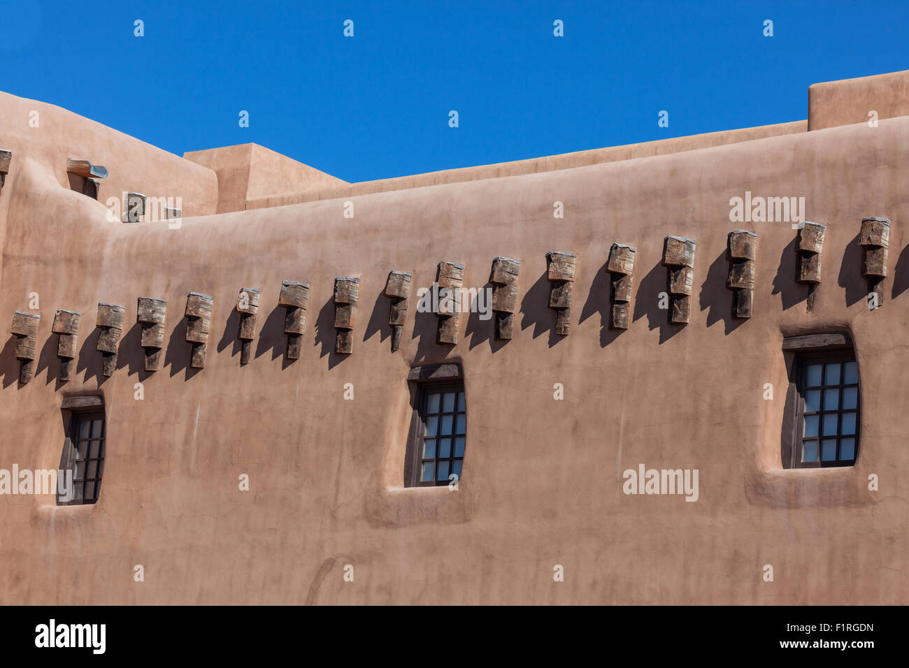 Adobe Building Windows A southwestern adobe style building with windows and beams in the ...