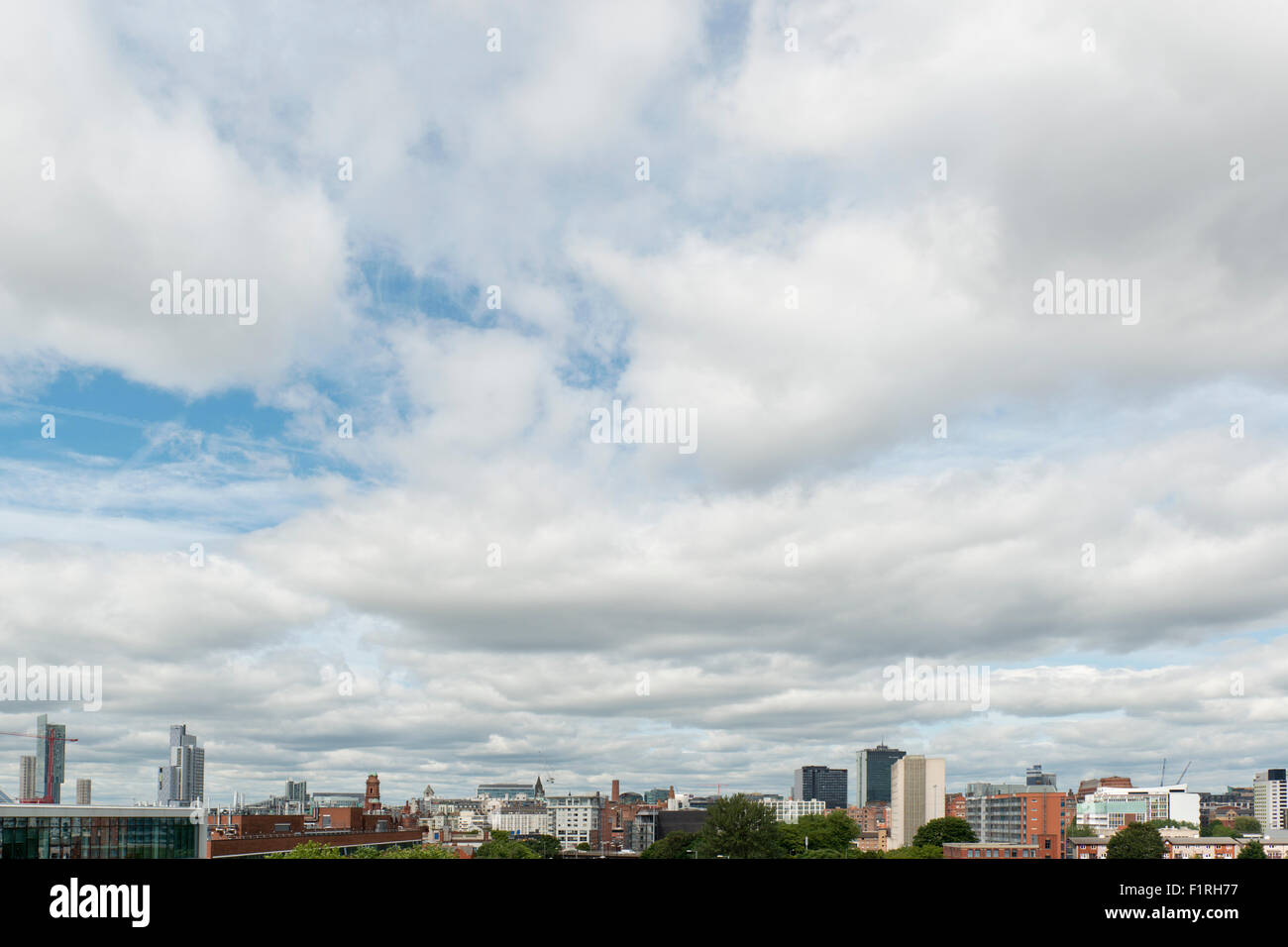 A shot of the city skyline of Manchester, UK, featuring various tall buildings and skyscrapers. Stock Photo