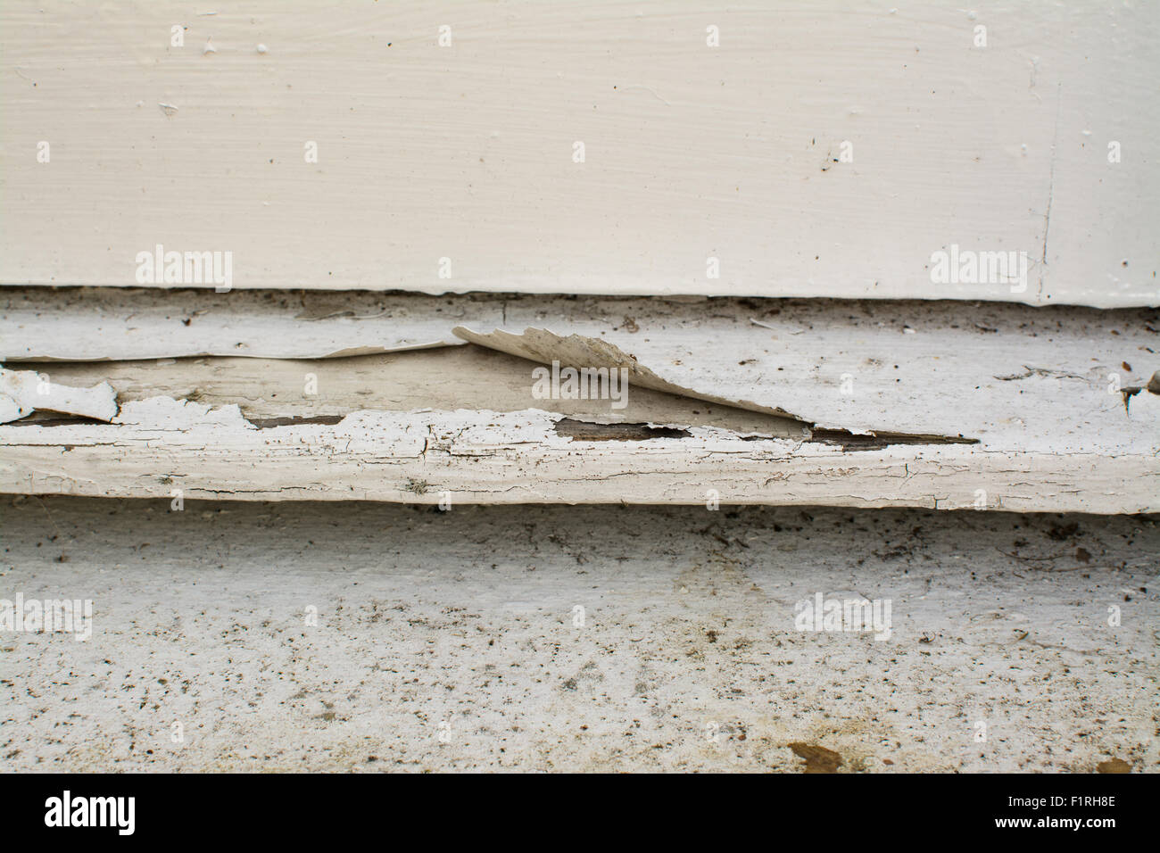 cracked paint peeling off external wooden window sill Stock Photo