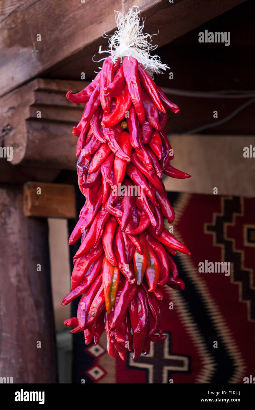 A group of red chile peppers hanging in a southwestern open air market ...