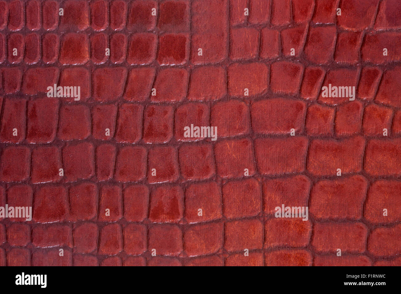 Red colored crocodile leather texture as abstract background Stock Photo