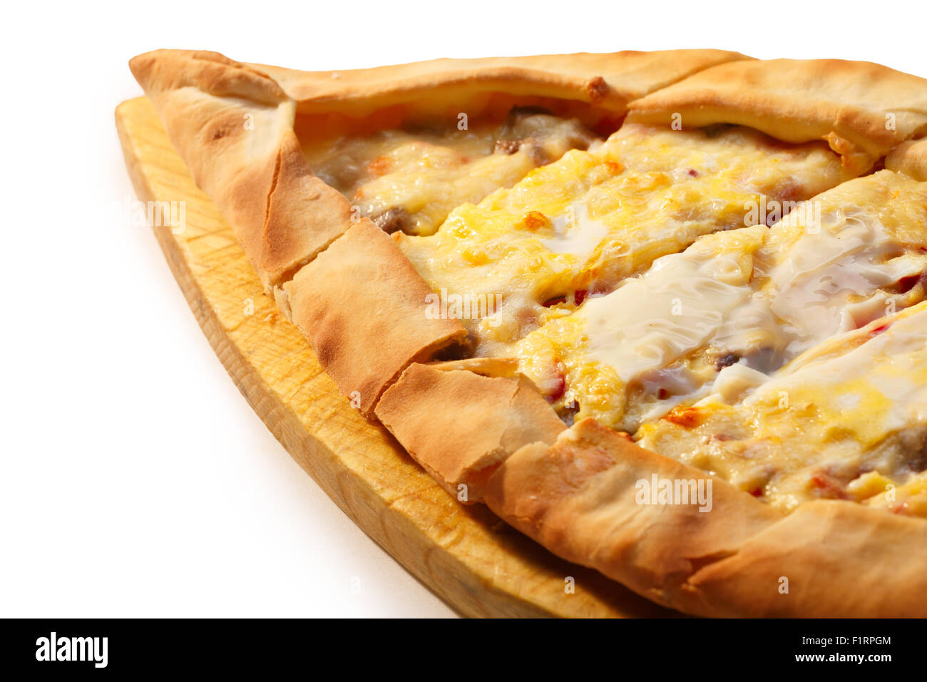 Sliced Turkish Pide on a wooden plate. Traditional Turkish pizza. Healthy dinner Stock Photo