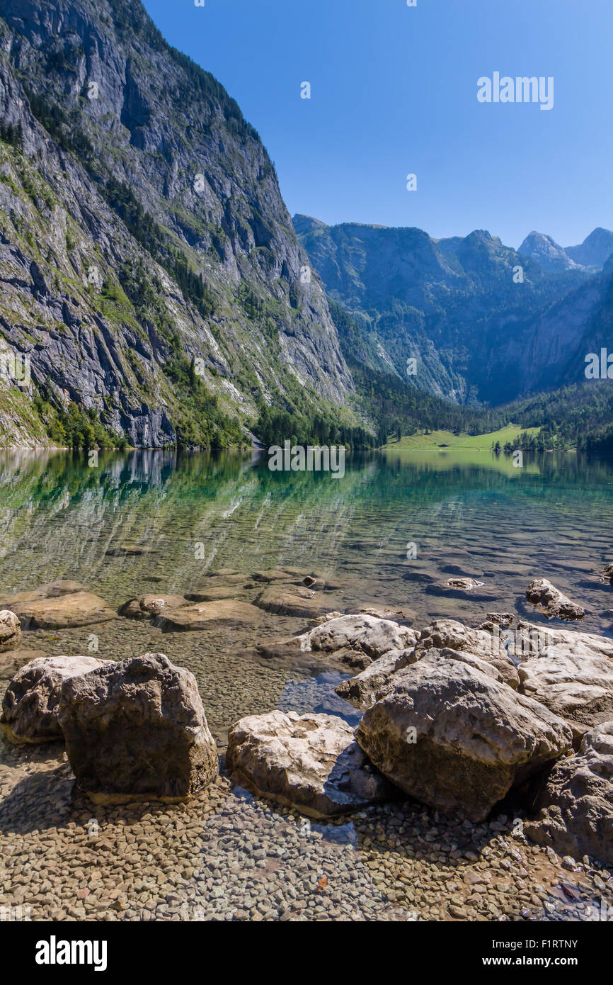 Beautiful landscape of alpine lake with crystal clear green water and mountains in background, Obersee, Germany Stock Photo