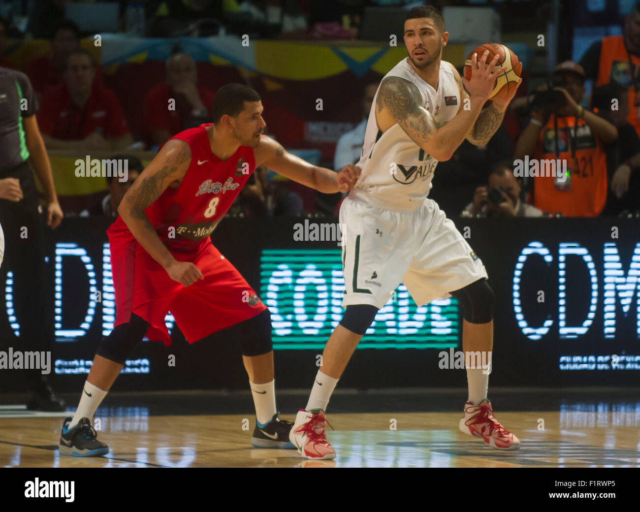 Mexico City, Mexico. 6th Sep, 2015. Mexico's Hector Hernandez (R) vies for the ball with Angel Vasallo of Puerto Rico during their match at the FIBA Americas 2015, held in the Palacio de los Deportes, in Mexico City, capital of Mexico, on Sept. 6, 2015. Mexico won the match. Credit:  Oscar Ramirez/Xinhua/Alamy Live News Stock Photo