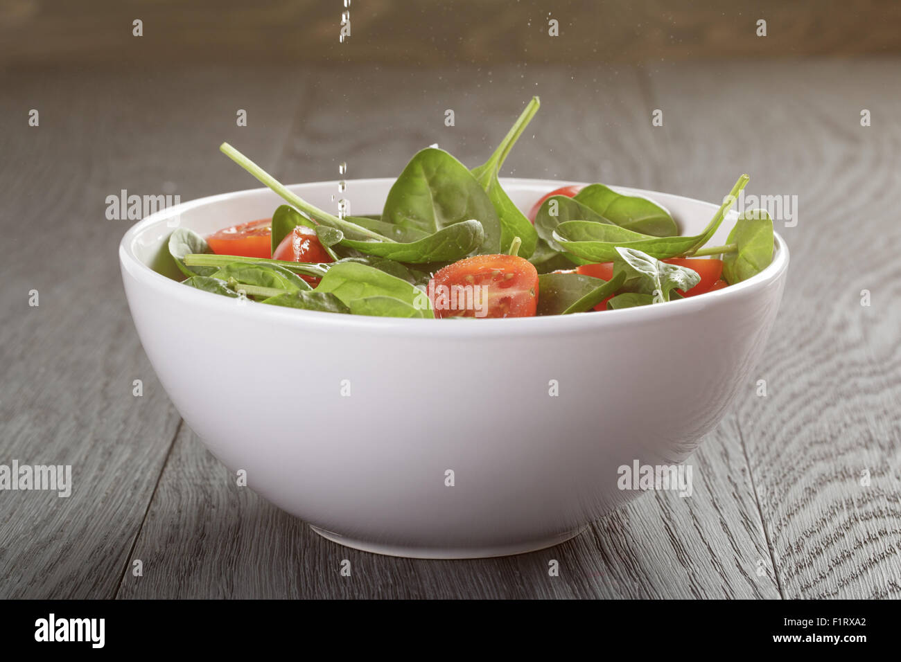 fresh summer organic salad with tomatoes cucumbers and spinach Stock Photo