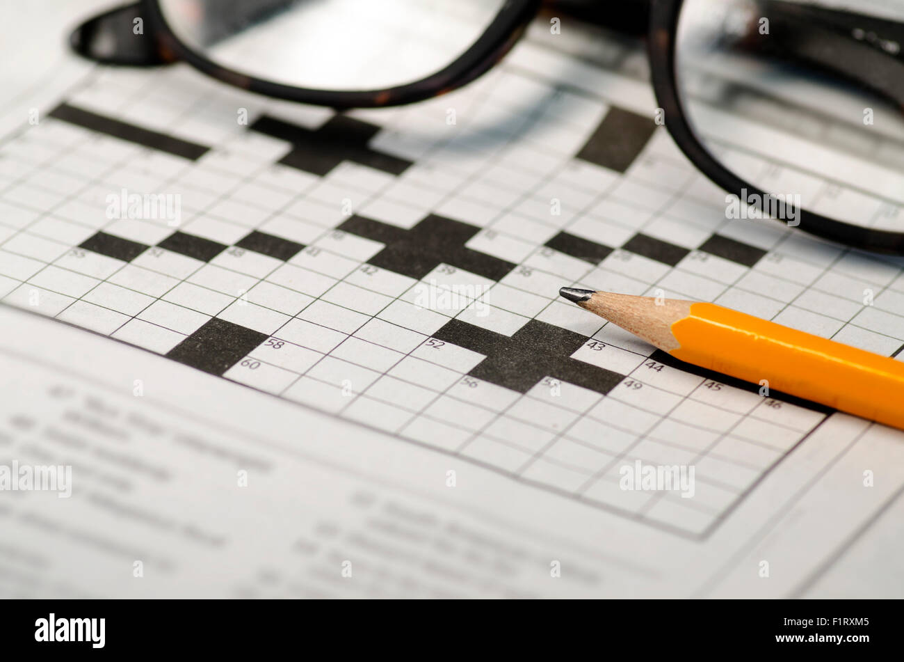 Crossword puzzle,pencil and reading glasses Stock Photo