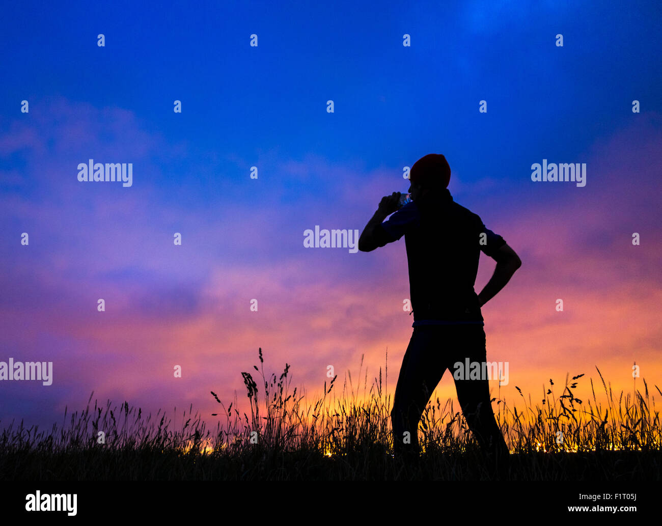 Cowpen Bewley Woodland Park, Billingham, UK. 7th September, 2015. Weather: Jogger on hill in woodland park silhouetted against glow from Teesside`s industrial skyline in pre dawn light on Monday morning. Credit:  Alan Dawson News/Alamy Live News Stock Photo