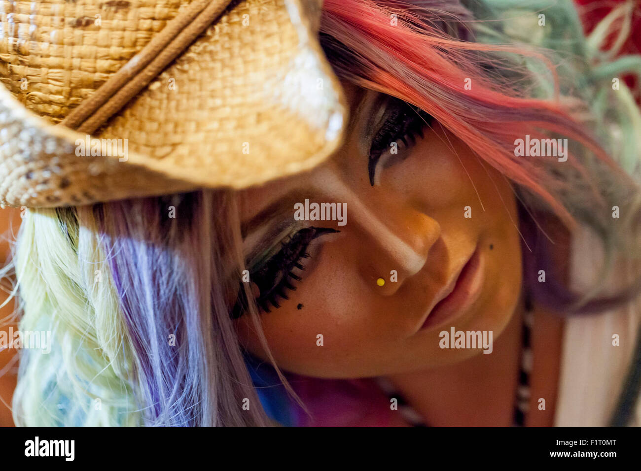 Erimokkori, a member of staff, poses for a picture at the Ganguro Cafe & Bar in the Shibuya shopping area on September 4, 2015. Ganguro is an alternative Japanese fashion trend which started in the mid-1990s where young women, rebelling against the traditional idea of Japanese beauty, wore colorful make-up and clothes and had dark-skin. 10 Ganguro fashion girls work in the new bar, which offers original Ganguro Balls (fried takoyaki style sausage balls in black squid ink batter) on its menu. Ganguro Café & Bar also offers special services such as Ganguro make-up and the chance to take purik Stock Photo