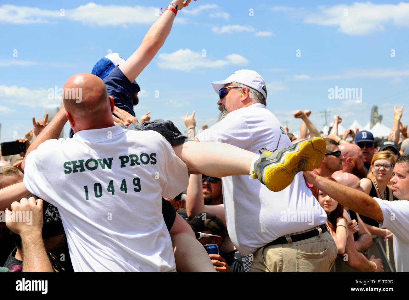Crowd control staff catches a crowd surfer at the Heavy Metal music festival the 2015 Monster Energy Carolina Rebellion Stock Photo
