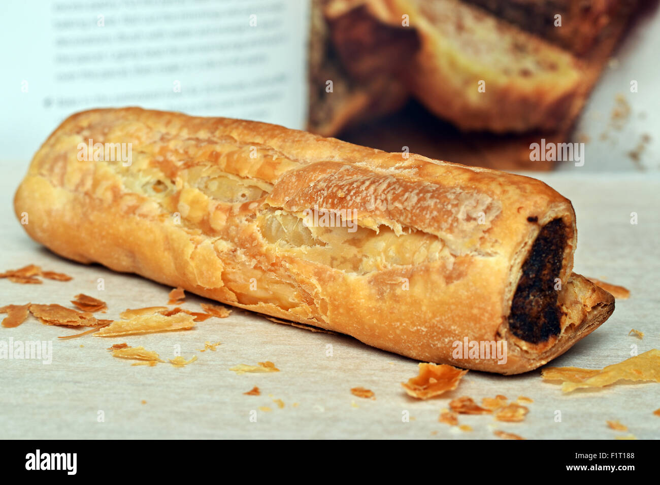 homemade sausage roll and open cookbook Stock Photo