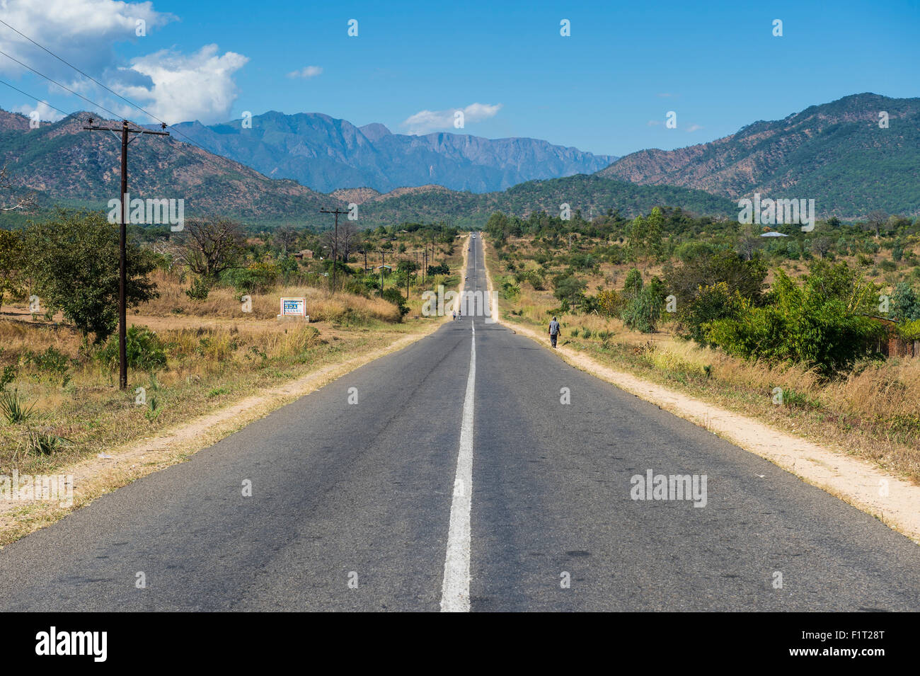Long straight road in central Malawi, Africa Stock Photo