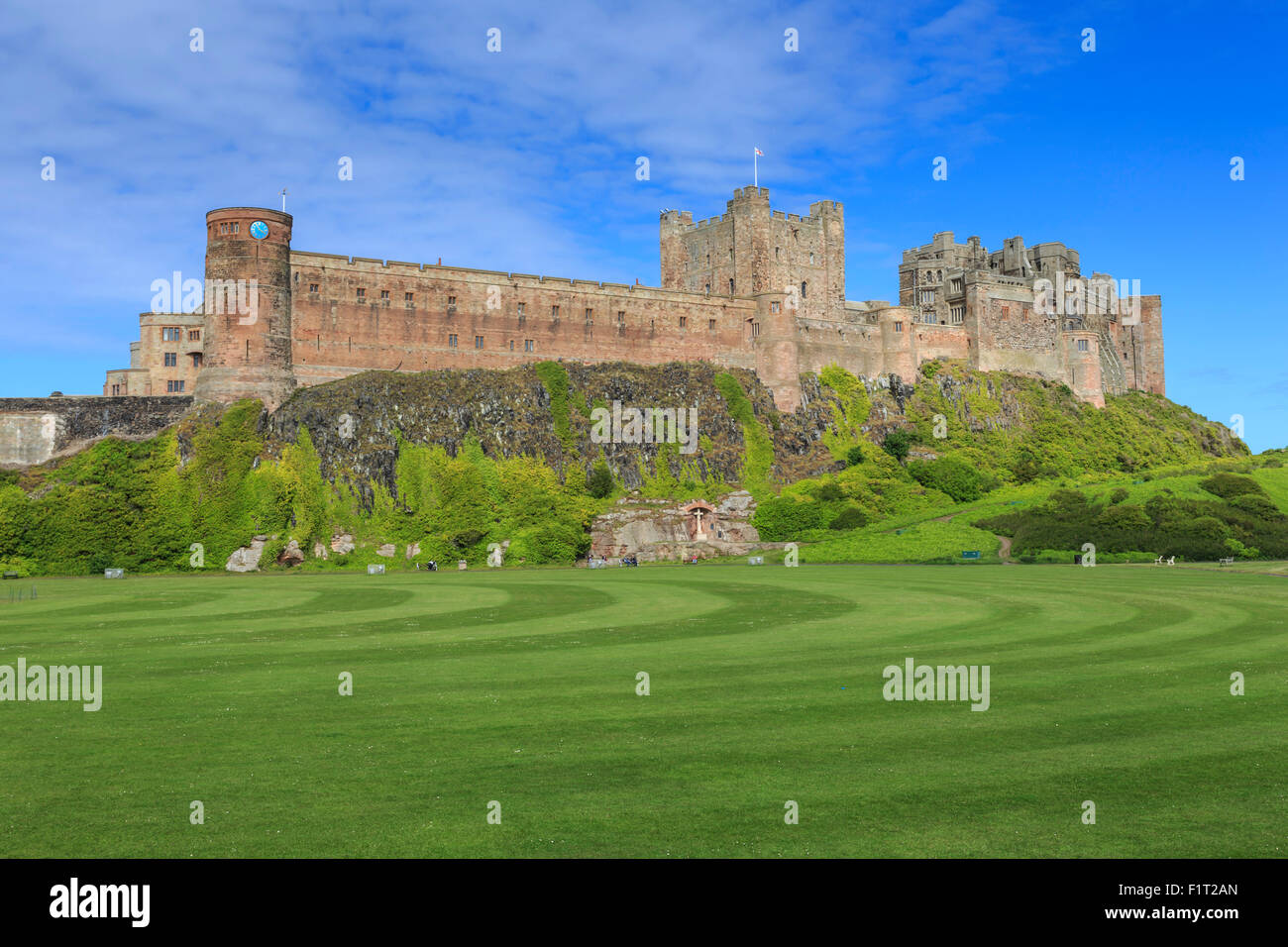 Bamburgh Castle under a blue summer sky, Bamburgh, Northumberland, England, United Kingdom, Europe Stock Photo
