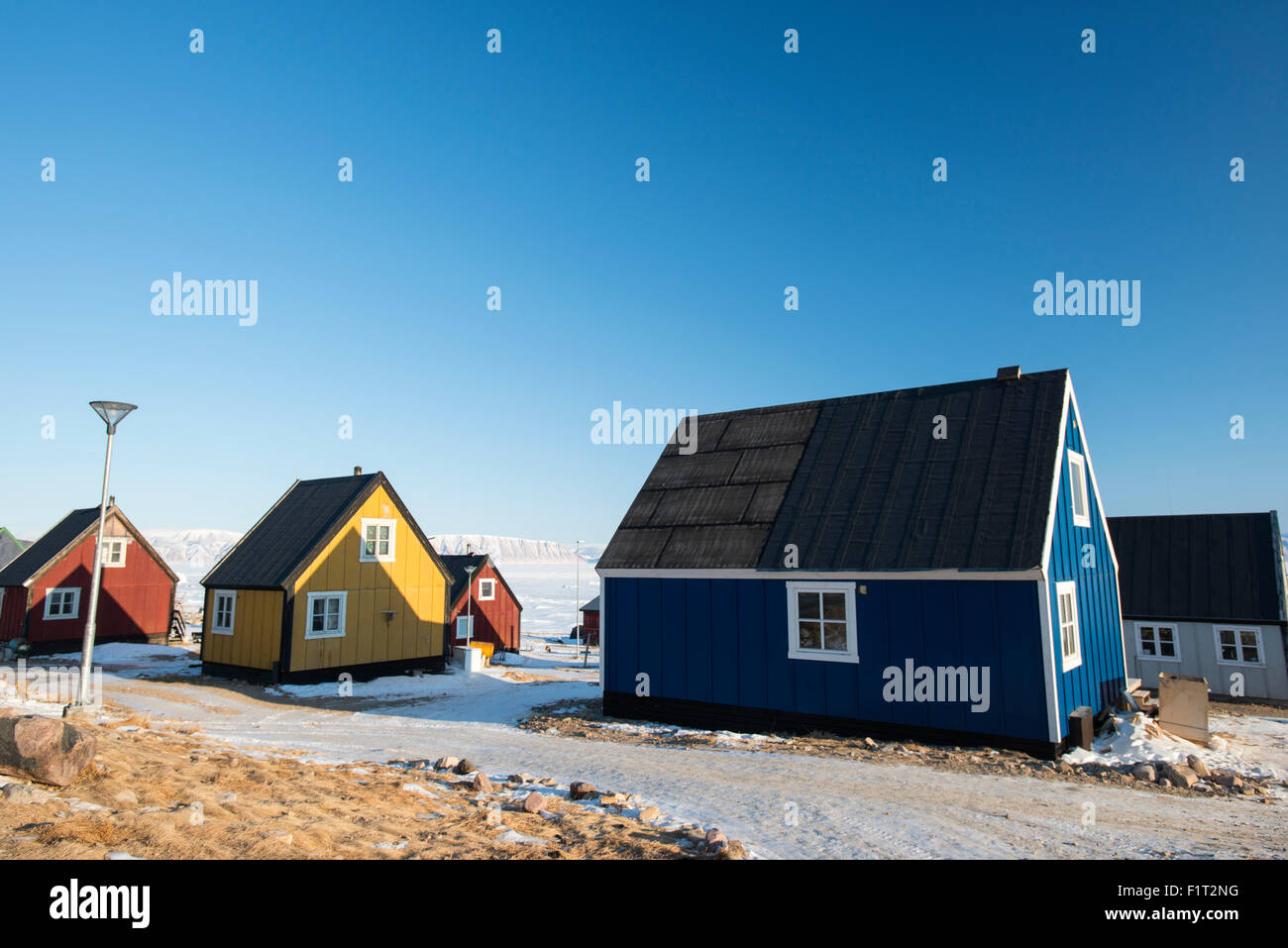 Colourful wooden houses in the village of Qaanaaq, one of the most northerly human settlements on the planet, Greenland, Denmark Stock Photo