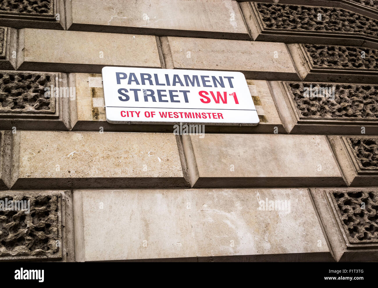 Famous Parliament Street road sign in London on a building exterior using traditional bright red text Stock Photo