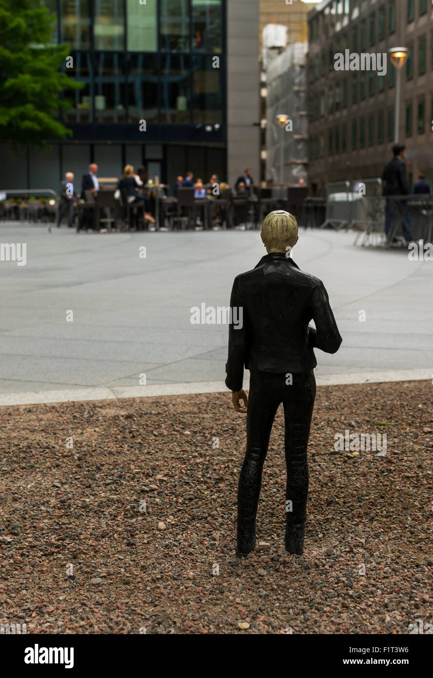 August 18th 2015 - Miniature human figure looks at city workers as part of an Art installation by Japanese artist Tomoaki Suzuki Stock Photo