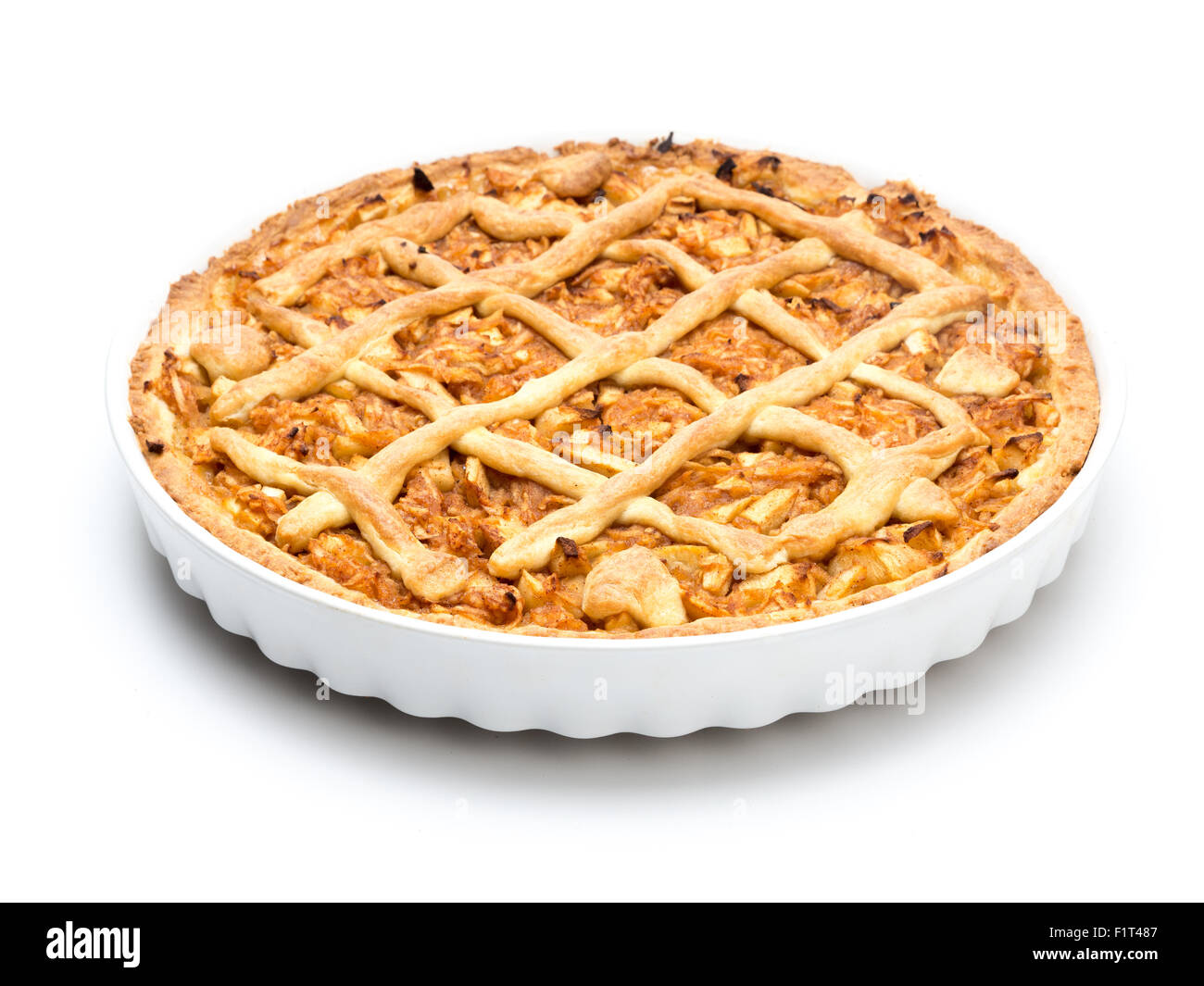 Apple pie in white ceramic pan on white background Stock Photo