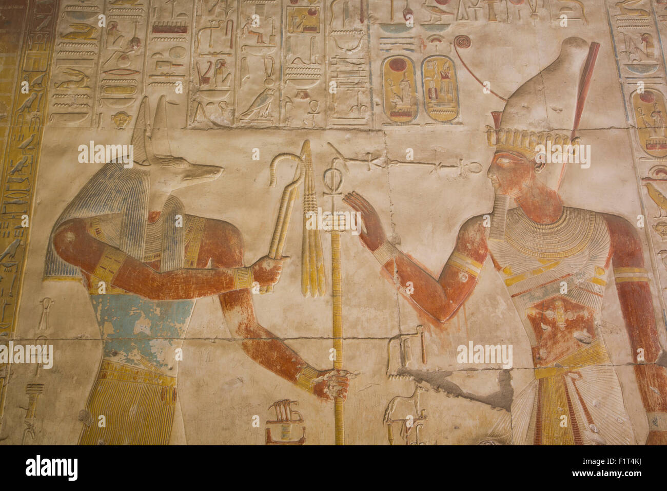 Bas-relief of the God Anubis on left and Ramses II on right, Temple of Seti I, Abydos, Egypt, North Africa, Africa Stock Photo