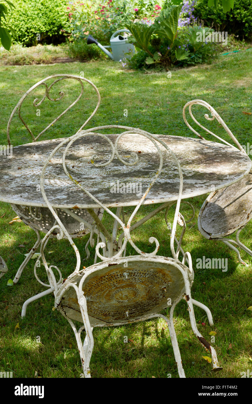 old rusty dusty iron chairs table garden Stock Photo