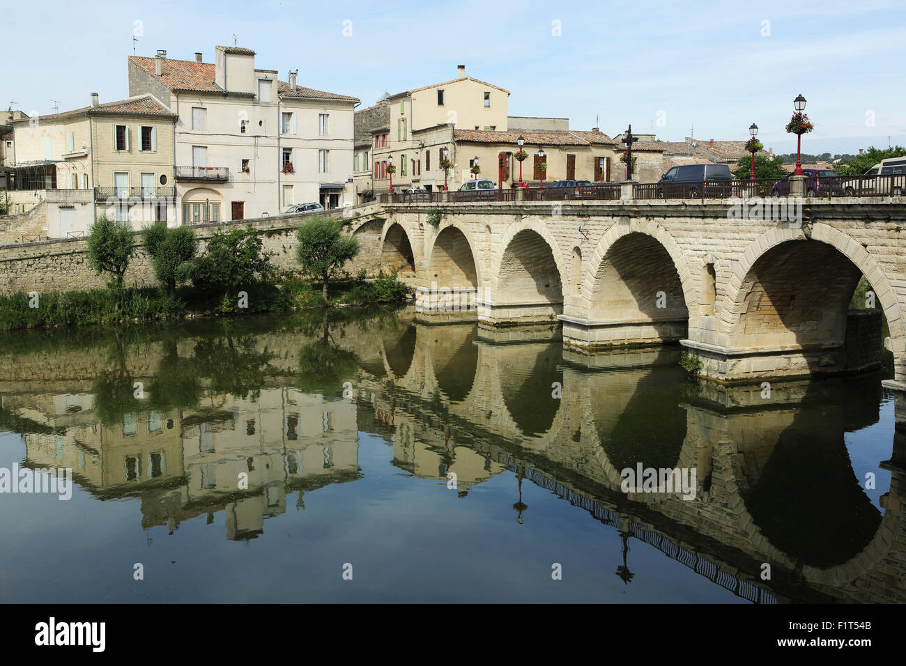 Roman Bridge, built in the reign of Emperor Tiberius, spans the River Vidourle at Sommieres, Gard, Languedoc-Roussillon, France Stock Photo
