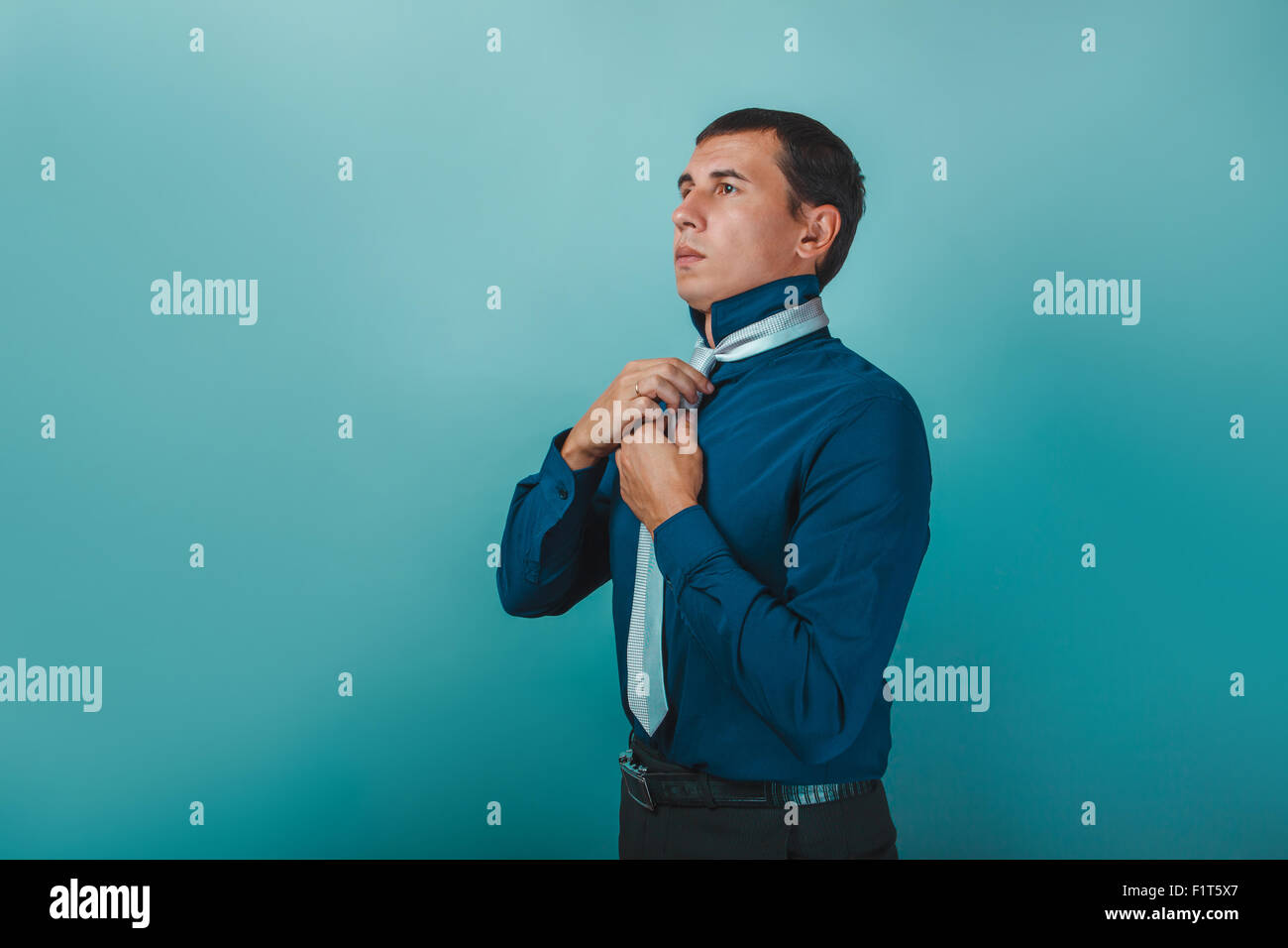 a man of European appearance thirty years straightens his tie on Stock Photo