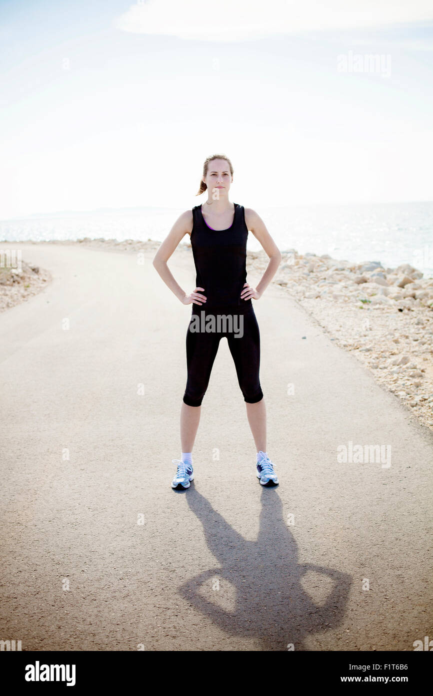 Young woman in sports clothing outdoors Stock Photo