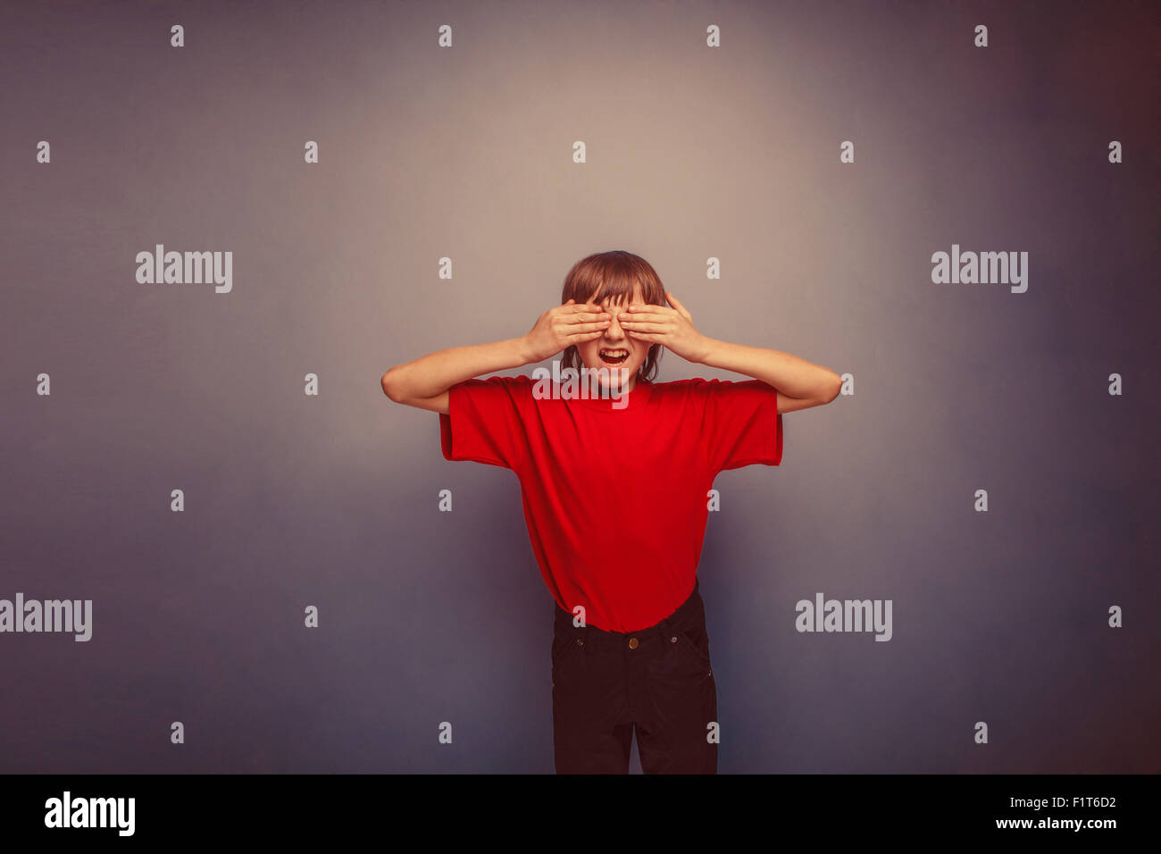 Boy, teenager, twelve years in the red shirt, closed his eyes, h Stock Photo
