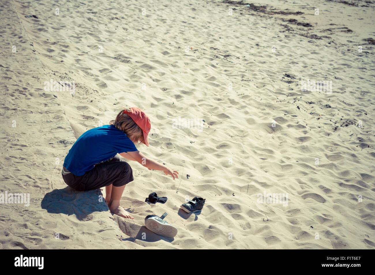 Young boy playing at the beach. Stock Photo