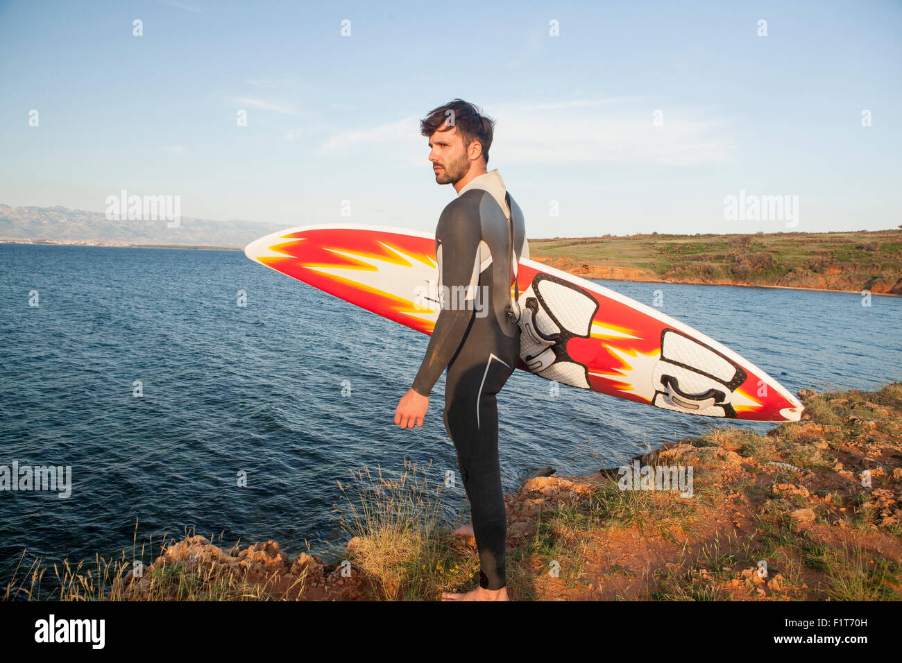 Surfer with surfboard on beach Stock Photo Alamy