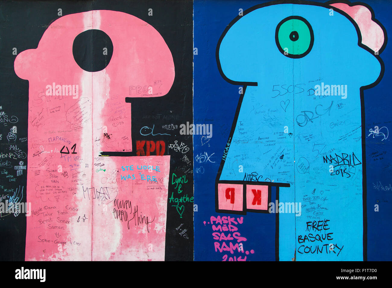 Pink and blue heads from the mural 'Some Heads' by Thierry Noir on the East Side Gallery, on August 8, 2015 in Berlin, Germany. Stock Photo