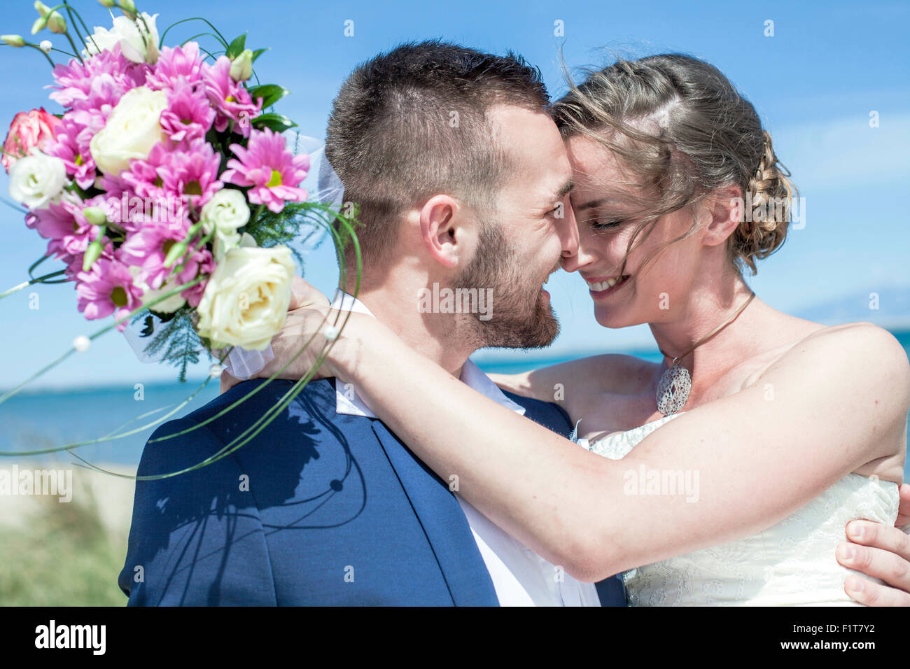 Bride and bridegroom embracing happily Stock Photo