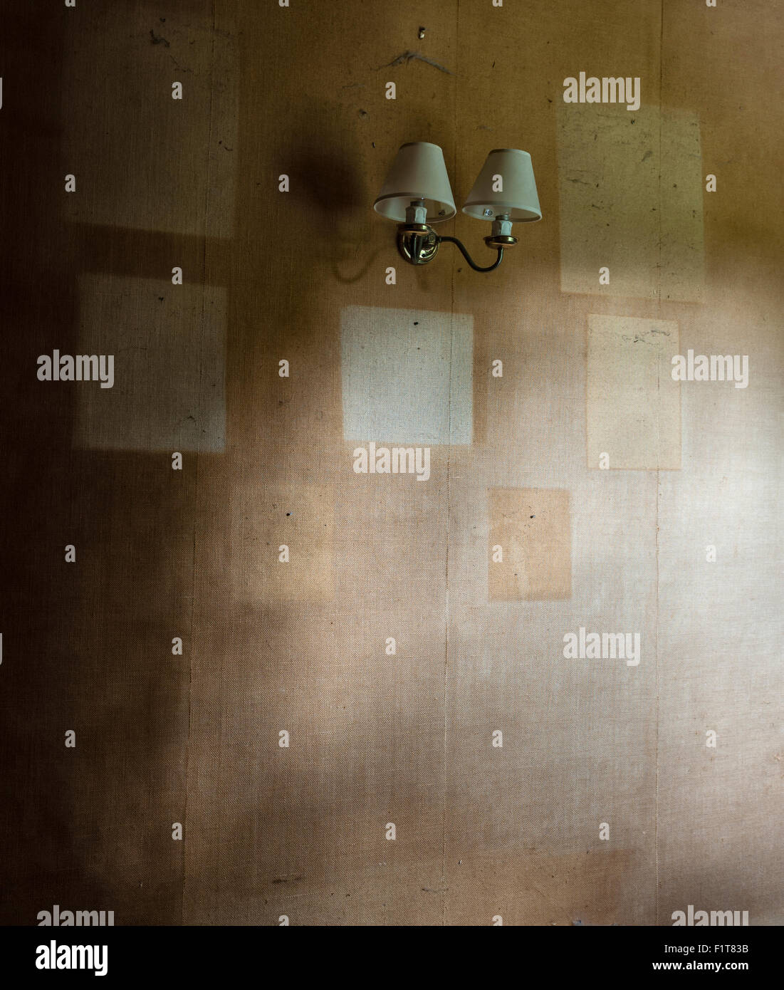 Moving house - after leaving, the ghostly outlines of framed pictures remain on an old faded wall in an empty room (UK) Stock Photo