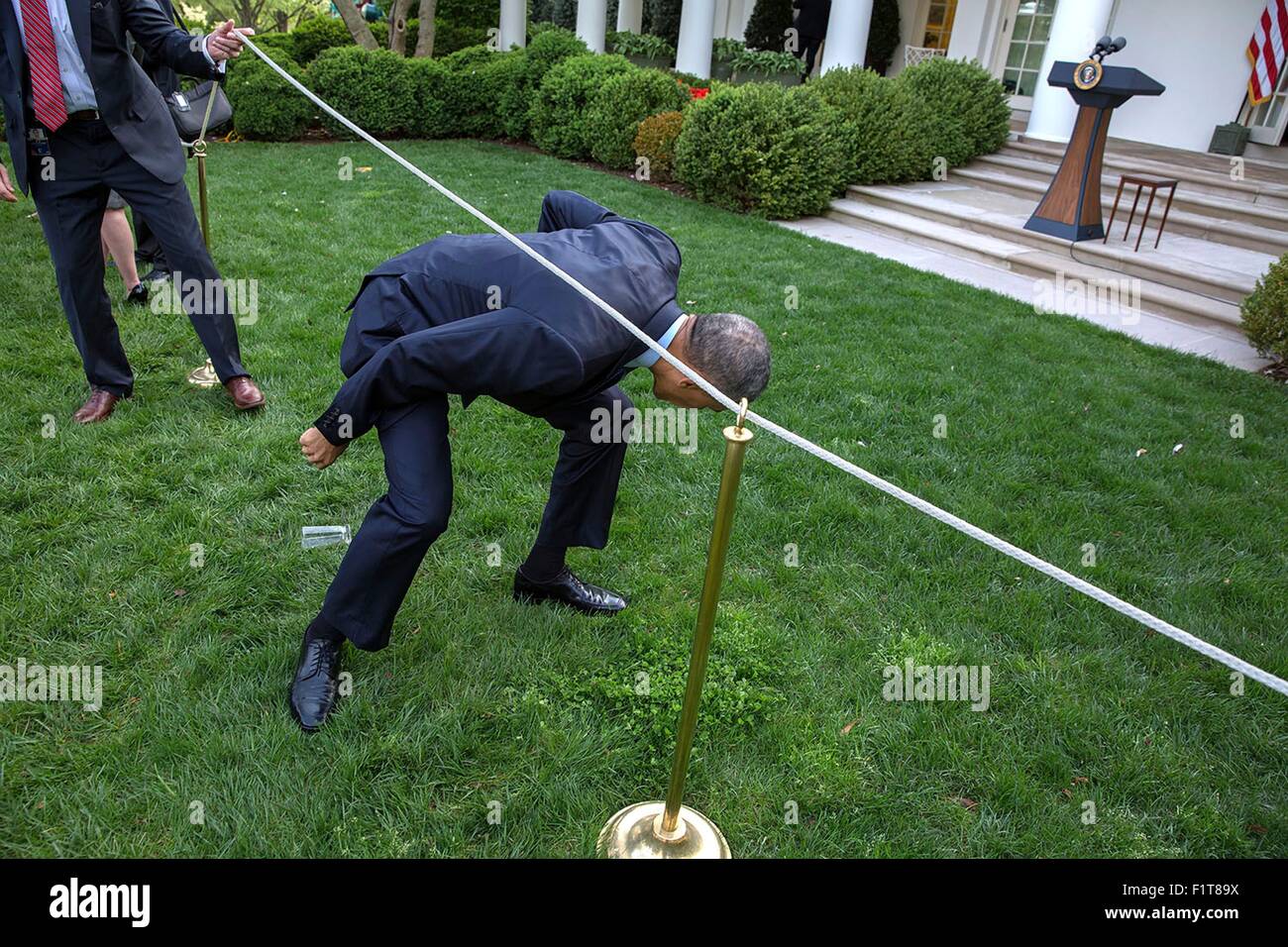 U.S. President Barack Obama climbs under a rope line as departs after greeting guests during a Medicare Sustainable Growth Rate reception in the Rose Garden of the White House April 21, 2015 in Washington, DC. Stock Photo