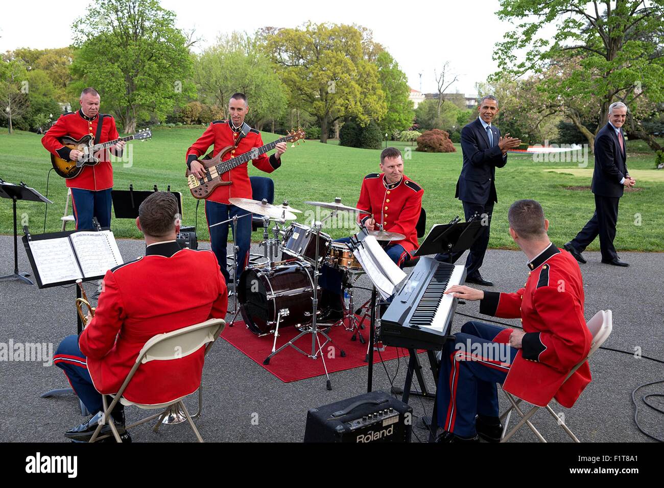 U.S. President Barack Obama and Chief of Staff Denis McDonough applaud the U.S. Marine Band Jazz Combo playing during a reception for the Medicare Sustainable Growth Rate in the Rose Garden of the White House April 21, 2015 in Washington, DC. Stock Photo
