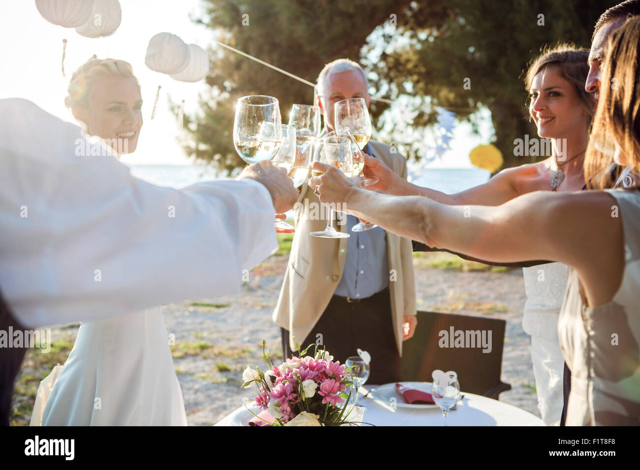 Drinking champagne at wedding reception on the beach Stock Photo