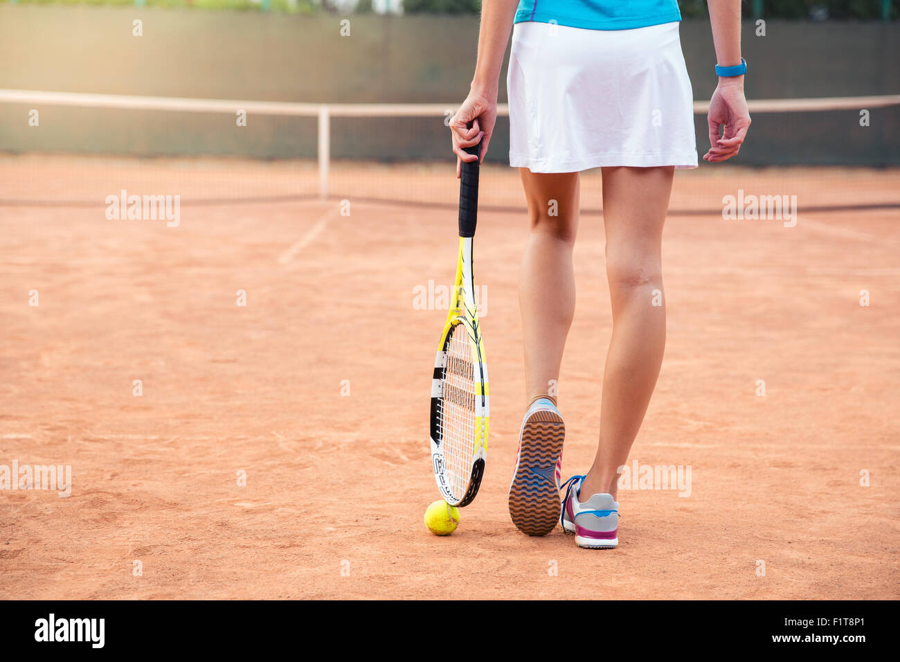 Closeup portrait of female legs with tennis racket Stock Photo