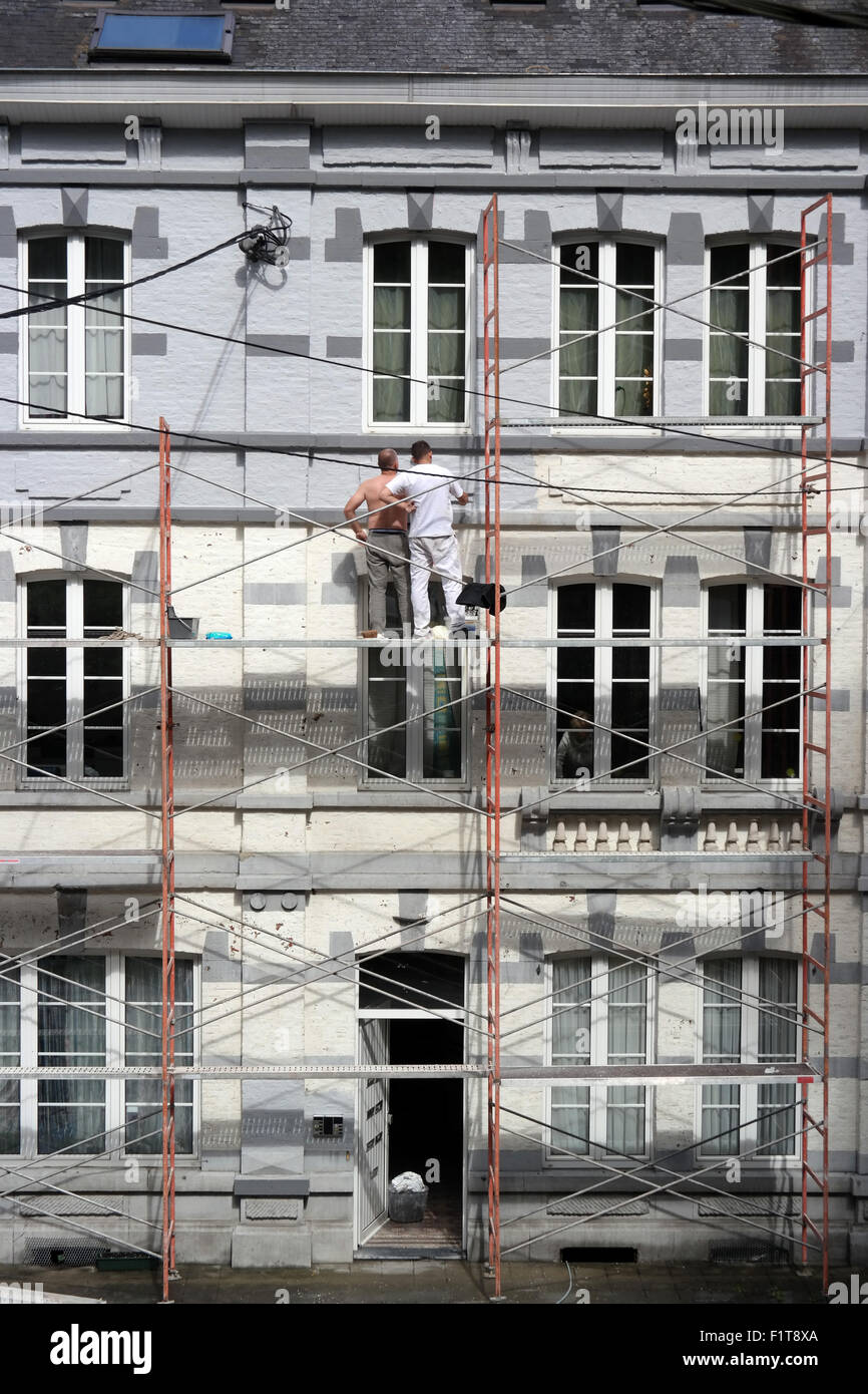 Two men working on scaffolding in the Belgian town La Roche Stock Photo