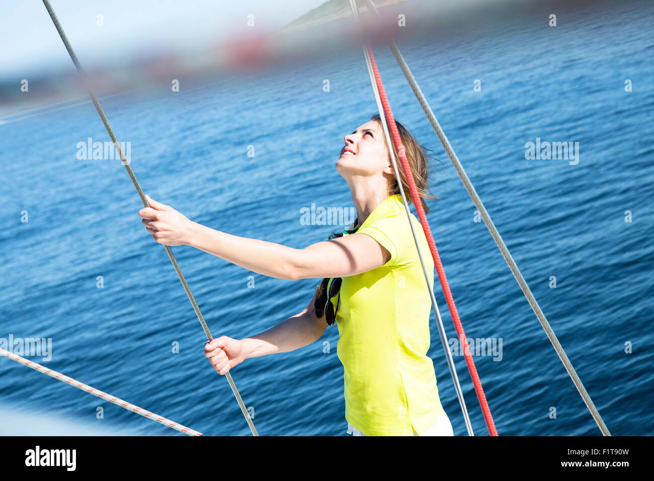 Woman adjusting rope on sailboat, Adriatic Sea Stock Photo