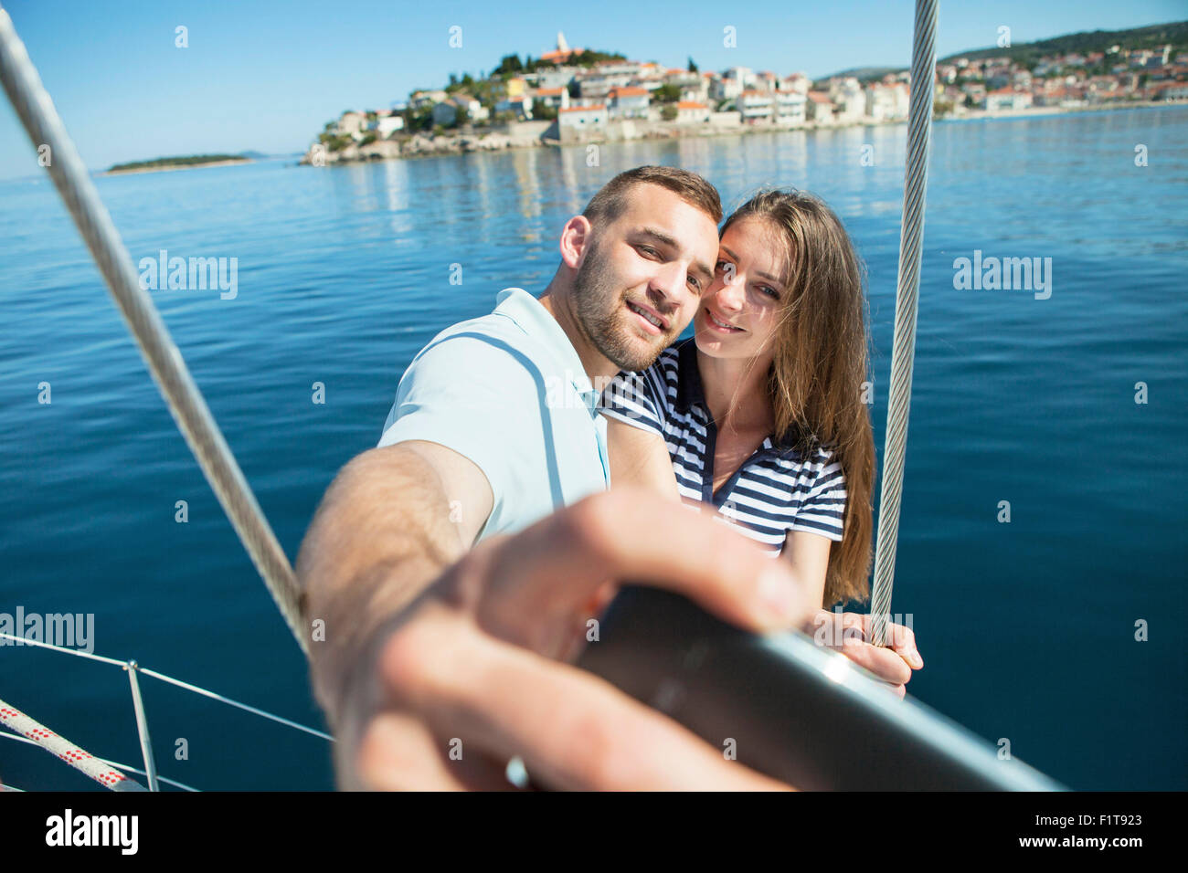 Couple photographing themselves on sailboat, Adriatic Sea Stock Photo