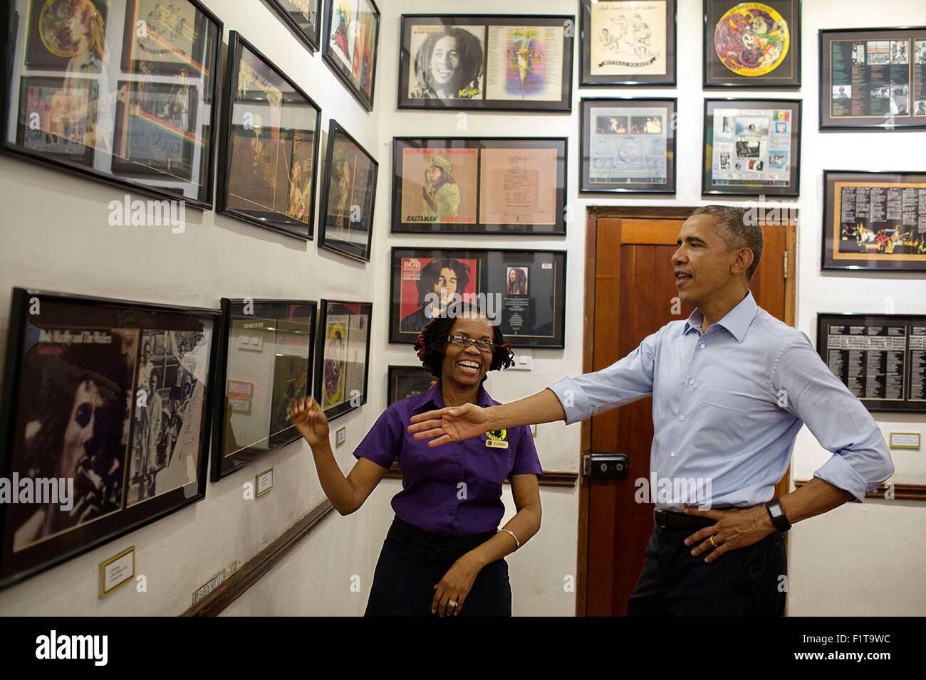 U.S. President Barack Obama looks at memorabilia with museum guide Natasha Clark during a visit to the Bob Marley Museum April 8, 2015 in Kingston, Jamaica. Stock Photo