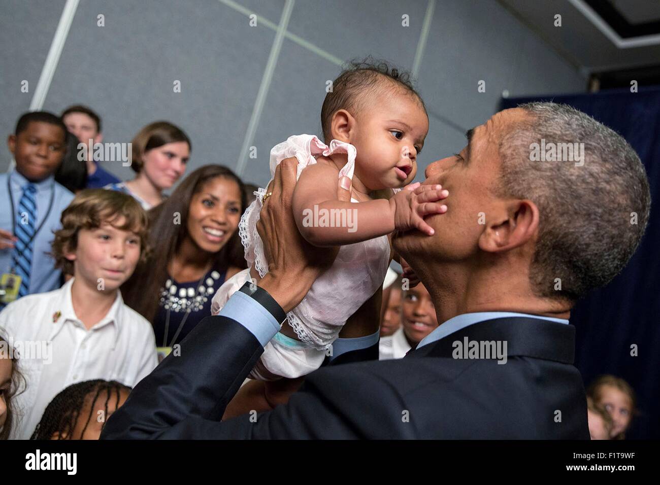 U.S. President Barack Obama holds a baby during a U.S. Embassy meet and greet April 8, 2015 in Kingston, Jamaica. Stock Photo