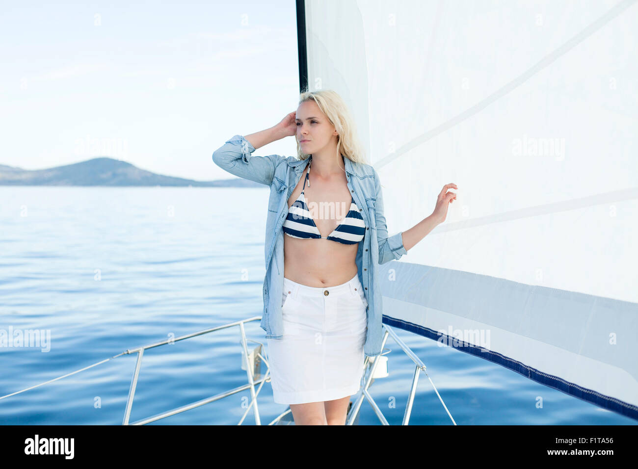 Young woman day dreaming on sailboat, Adriatic Sea Stock Photo