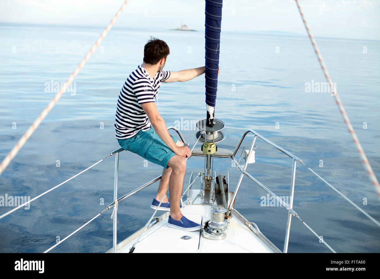 Man listening to music on sailboat, Adriatic Sea Stock Photo