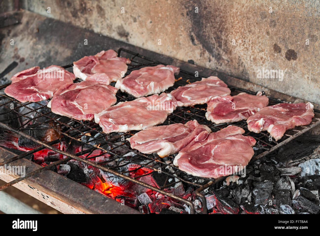 raw meat grilled over charcoal Stock Photo
