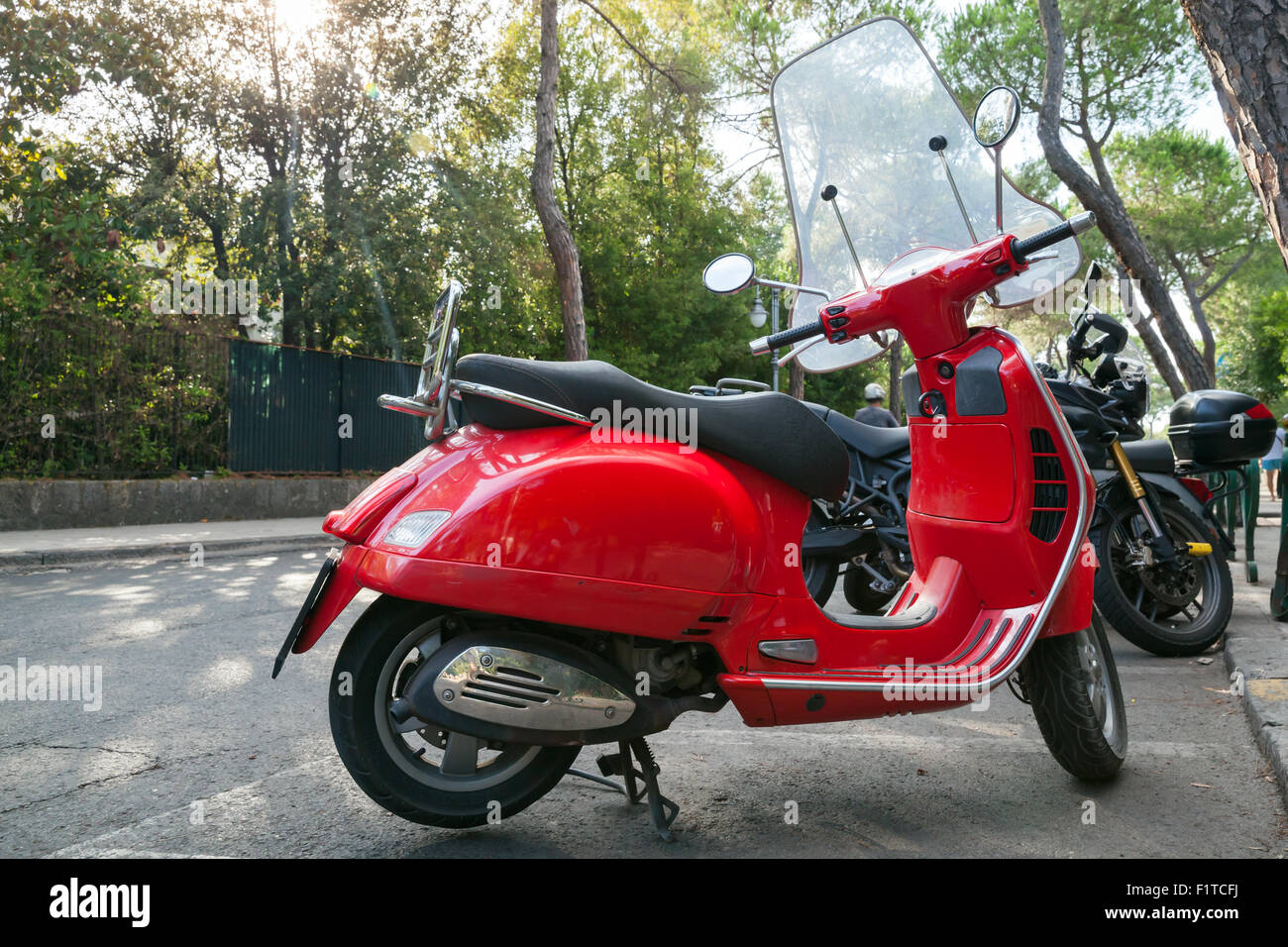 Ischia, Italy - August 15, 2015: Classic red old style Vespa scooter stands parked on a roadside Stock Photo