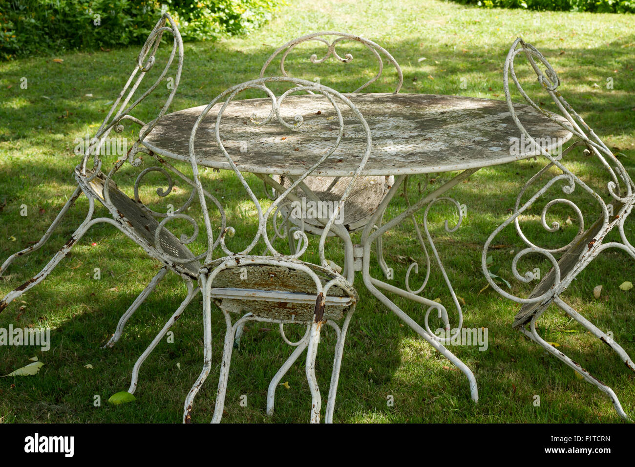 old rusty dusty iron chairs table garden Stock Photo